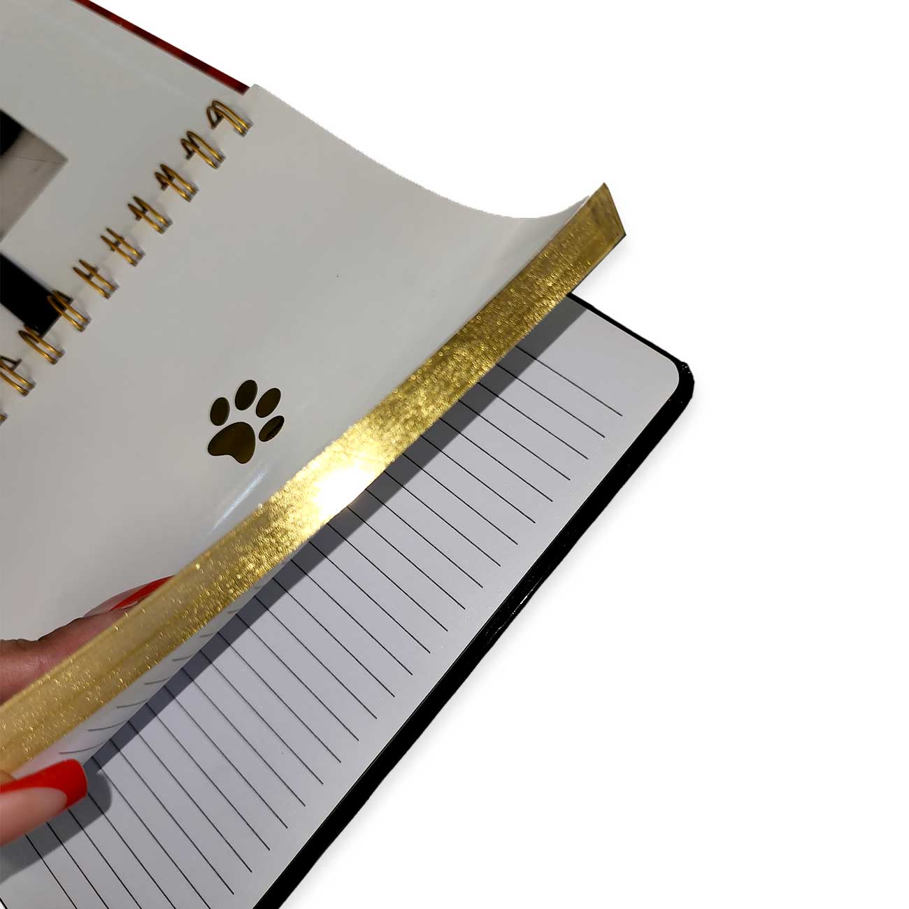 Notebook with gold glittery edge and paw print design on a white background