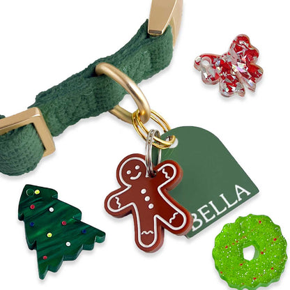Green dog collar with Christmas-themed charms and a name tag on a white background
