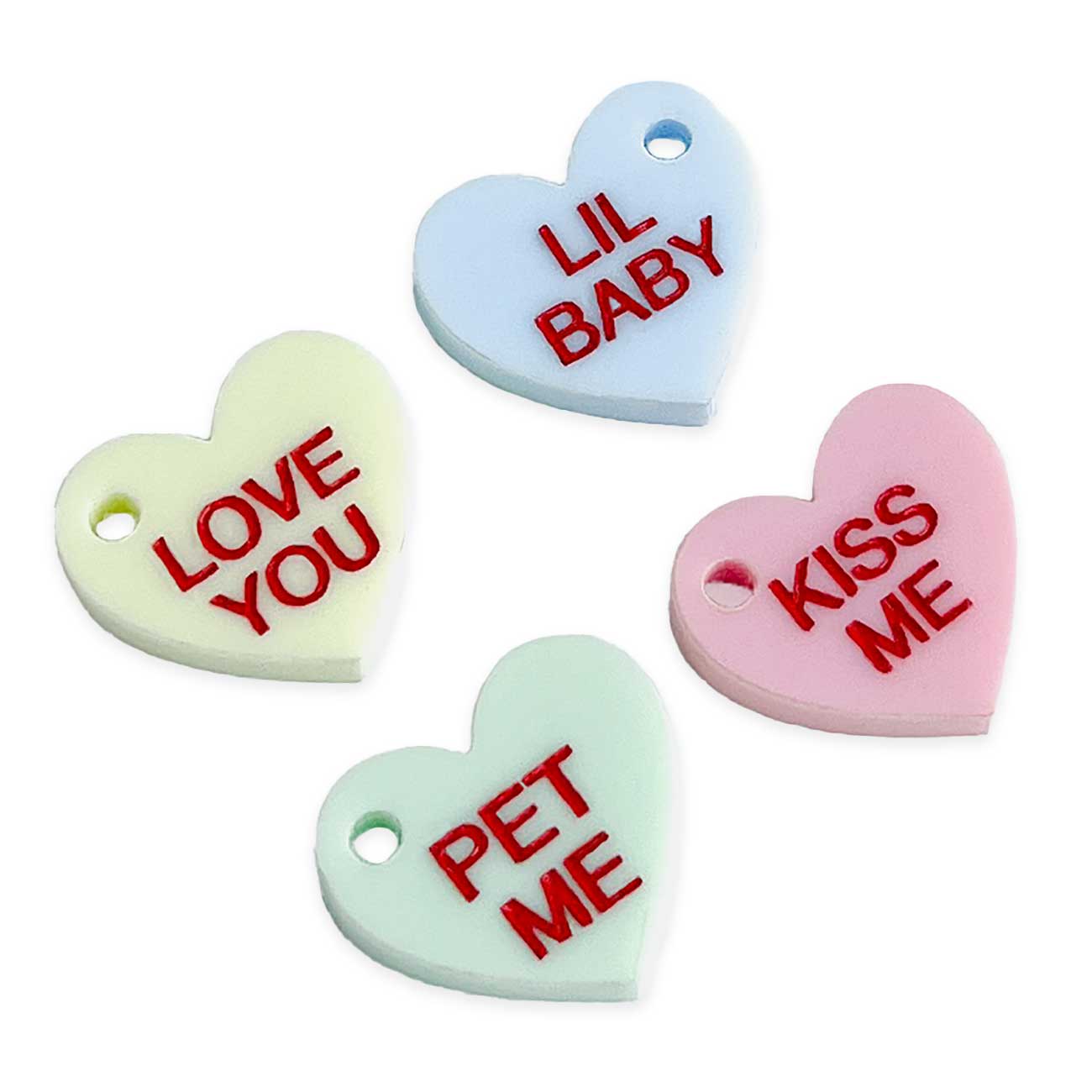 Four heart-shaped tokens with red text on a white background