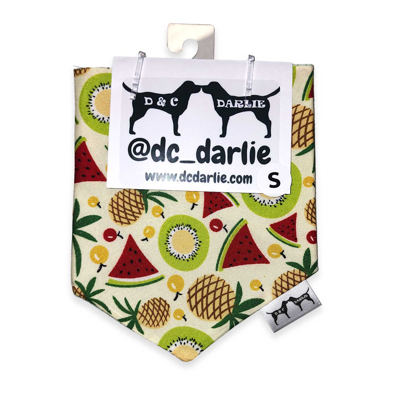 Fruit patterned dog bandana with brand label on a white background