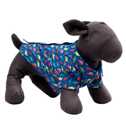 Stuffed animal wearing a blue dog shirt with colorful dinosaur pattern on a white background