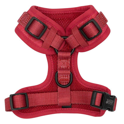 Red dog harness with black buckles on a white background