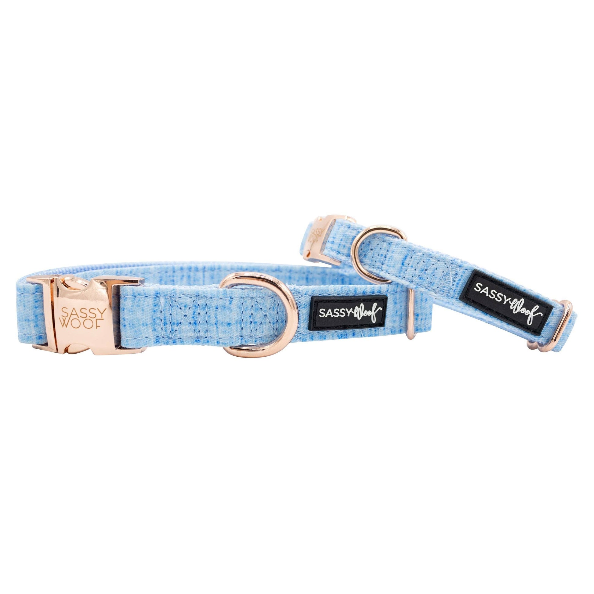 Dog collar with rose gold hardware and blue fabric on a white background