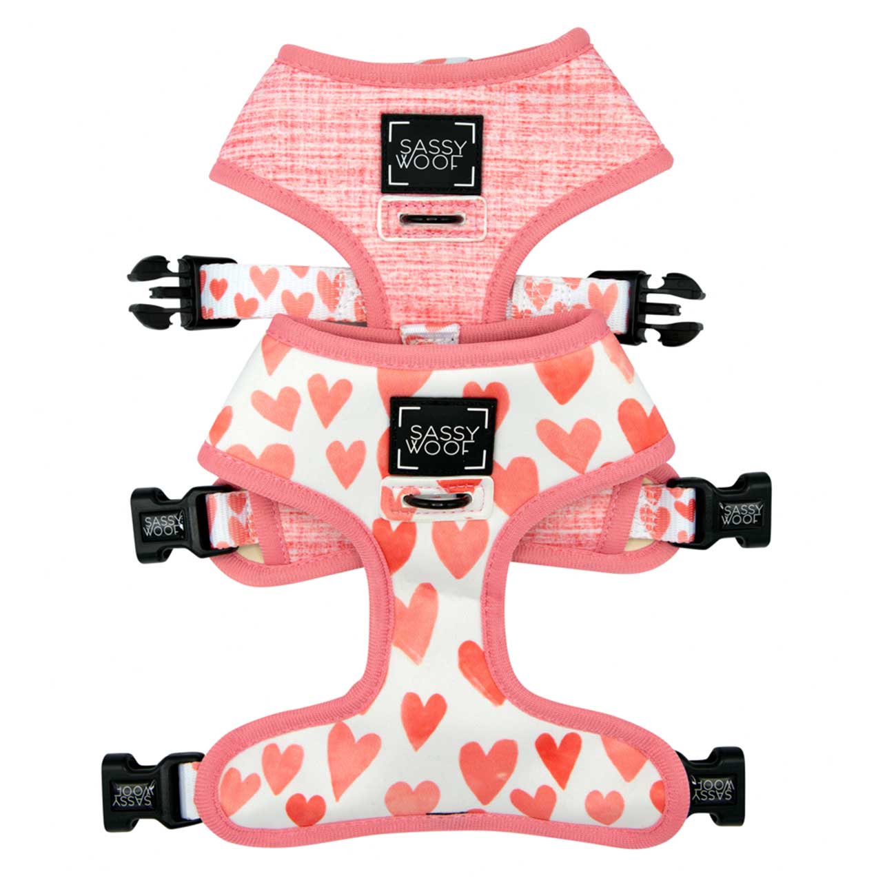 Two dog harnesses with heart patterns and 'Sassy Woof' branding on a white background.