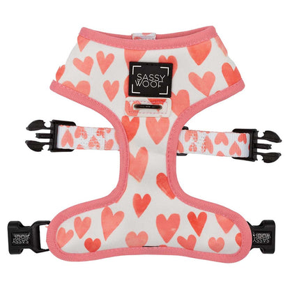 Dog harness with pink heart pattern and 'Sassy Woof' branding on a white background