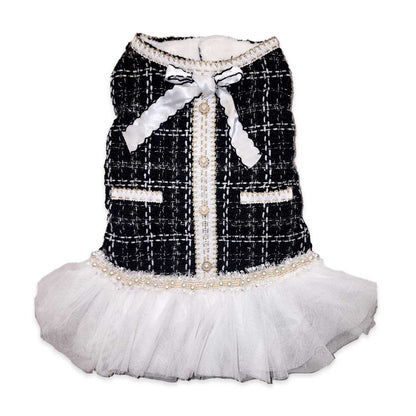 Dog dress with black tweed pattern, white bow, and skirt on a white background
