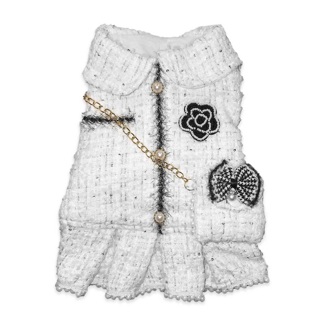White textured dress with black floral and bow details on a white background
