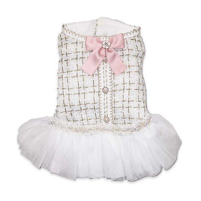 Dog dress with white checkered pattern, pink bow, and white skirt on a white background