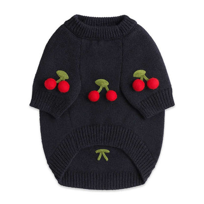 Navy blue knitted dog sweater with cherry designs on a white background