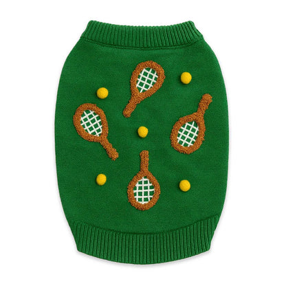 Green dog sweater with tennis racket and ball designs on a white background