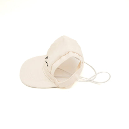 Beige visor cap with a small logo on a white background