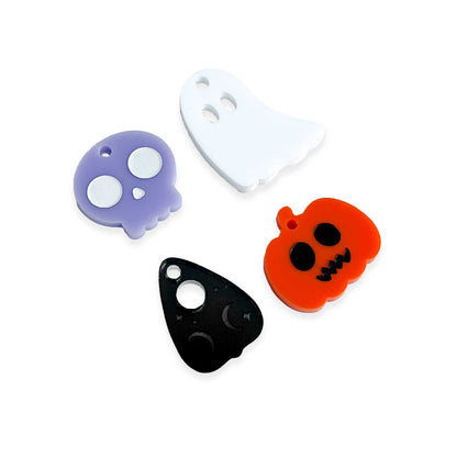 Four Halloween-themed silicone charms on a white background