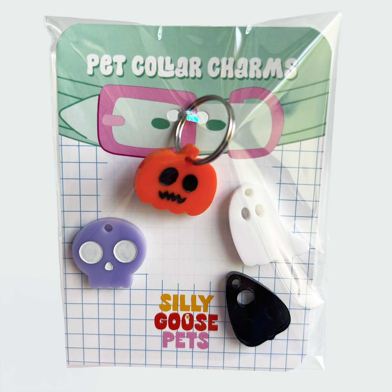Pet collar charms in packaging with 'Silly Goose Pets' branding
