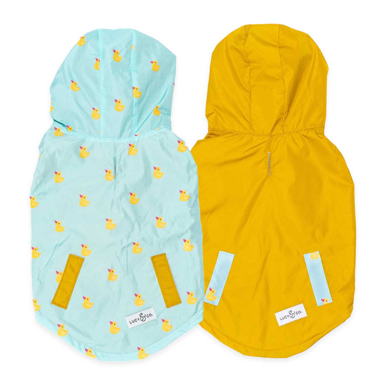 Two hooded dog coats, one light blue with duck pattern and one yellow showcasing the reversible feature, on a white background.