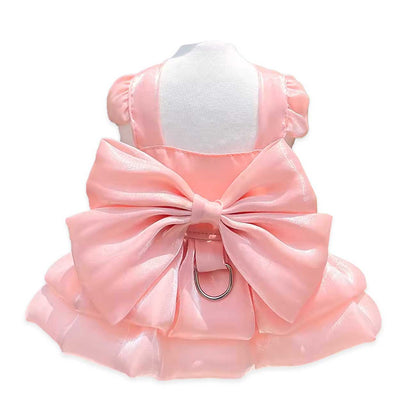 Pink dog dress with a large bow on a white background