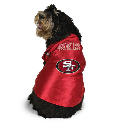 Dog wearing a red San Francisco 49ers jacket on a white background
