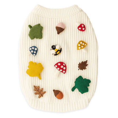 Dog sweater with autumn-themed 3D icons on a white background