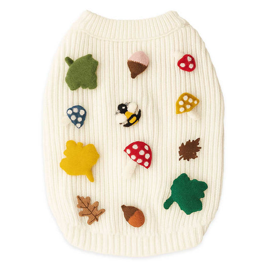 Dog sweater with autumn-themed 3D icons on a white background