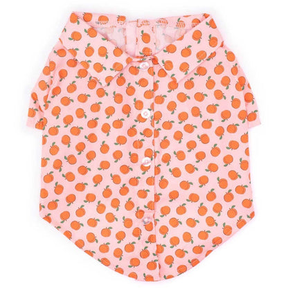 Pink shirt with orange peach pattern on a white background