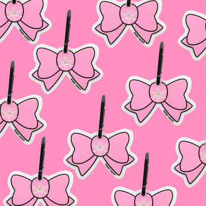 Pattern of pink bow-shaped dog waste bag holder on a pink background