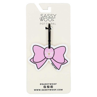 Pink bow design on a Sassy Woof branded card with a black clip.
