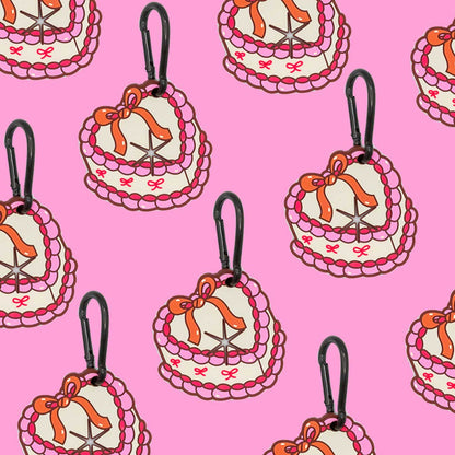 Heart-shaped dog waste bag holders with bows on a pink background