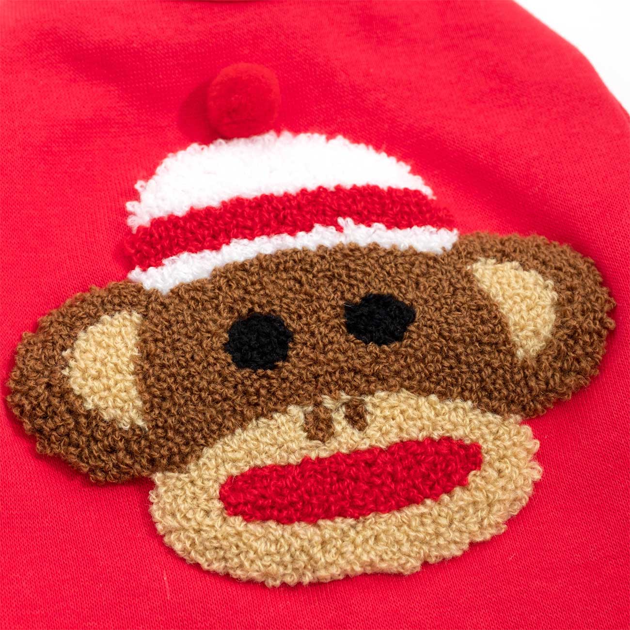 Sock monkey face patch on a red background