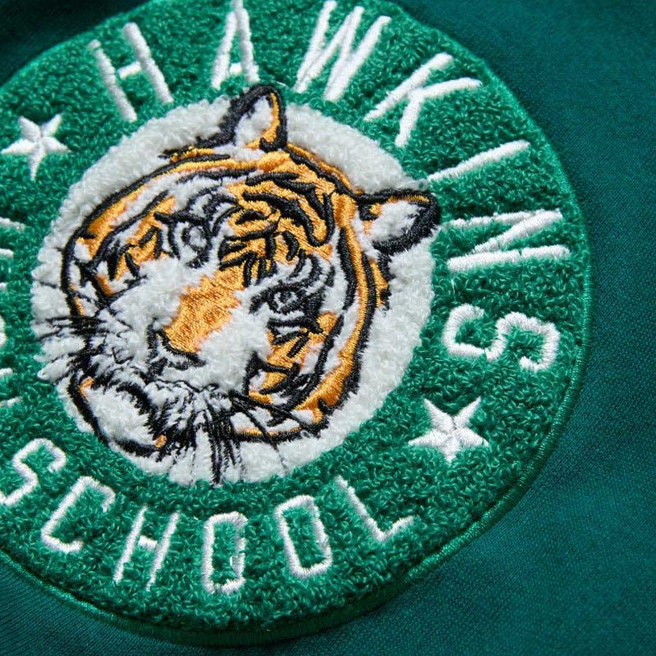 Embroidered patch with a tiger and 'Hawkins School' text on a green background