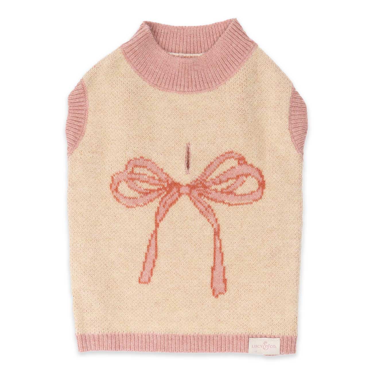 Dog sweater with pink bow design on a beige background