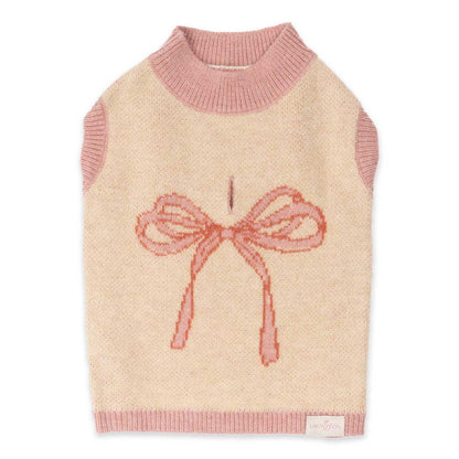 Dog sweater with pink bow design on a beige background