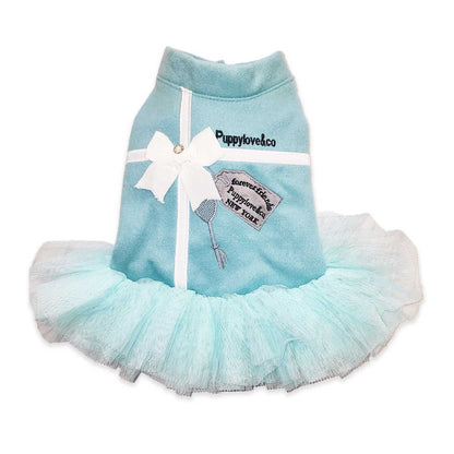 Light blue pet dress with a white bow and 'Puppylovesco' branding on a white background