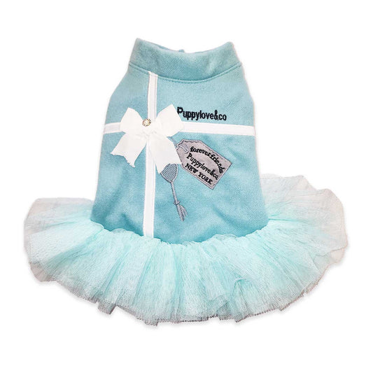 Light blue pet dress with a white bow and 'Puppylovesco' branding on a white background
