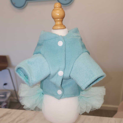 Light blue baby outfit with ruffles on a mannequin against a neutral background