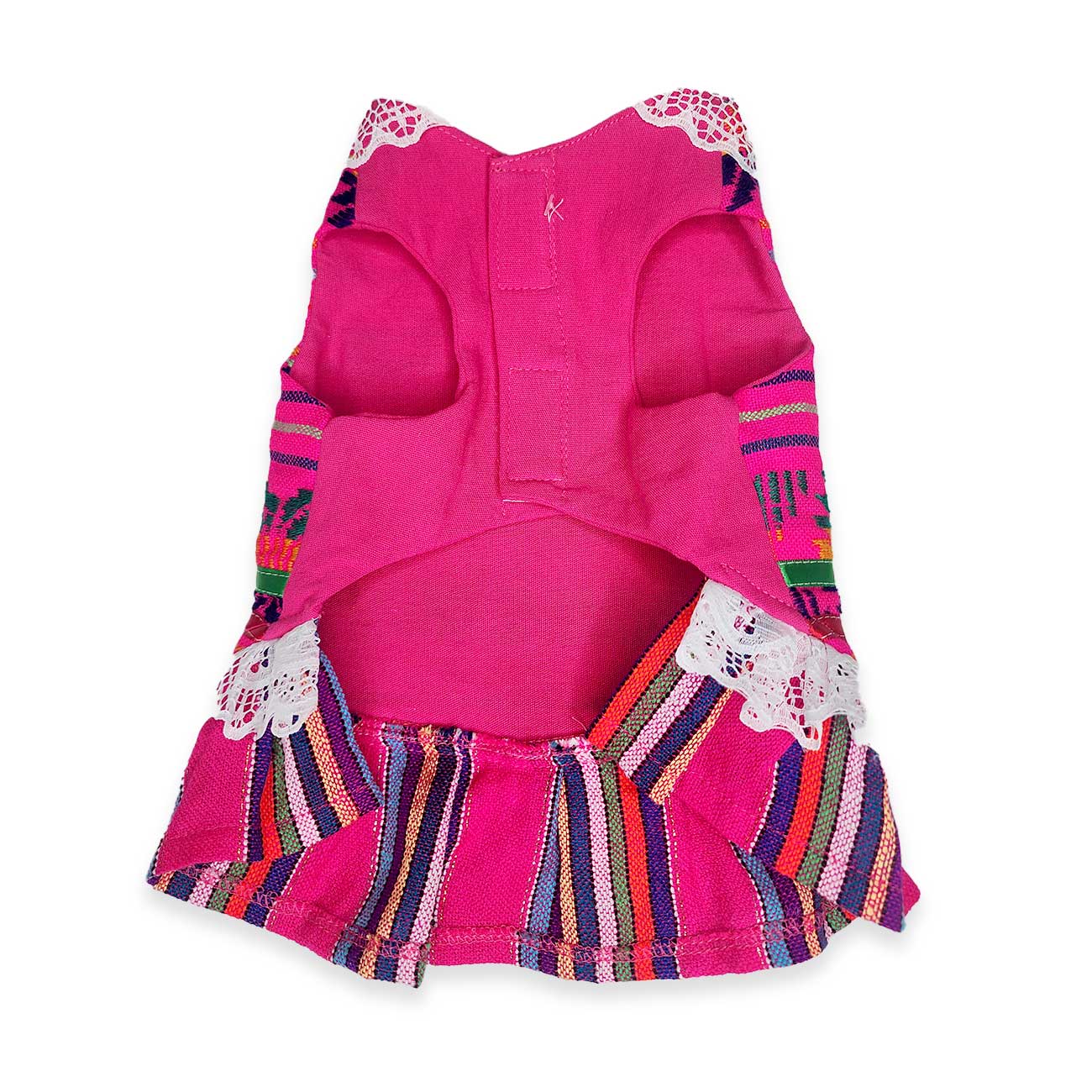 Pink dog dress with colorful patterned trim on a white background