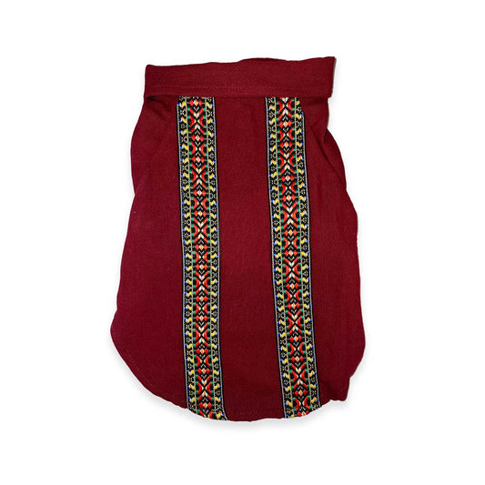 Maroon dog shirt with colorful geometric patterns on a white background