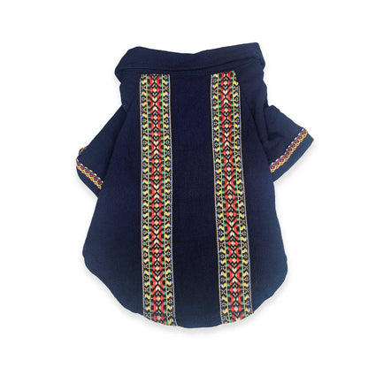 Navy blue dog shirt with colorful geometric patterns on a white background