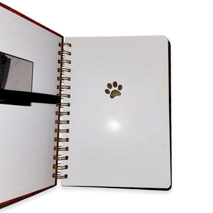 Open notebook with a paw print design on a white background