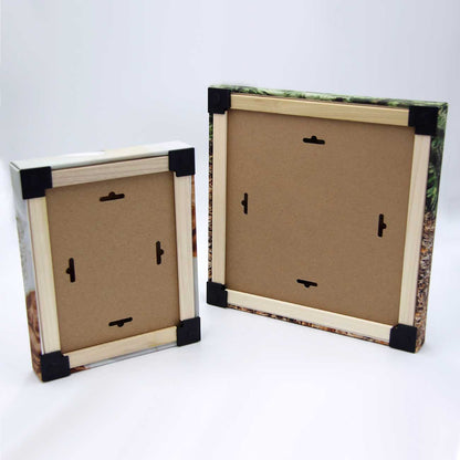 Back side of two canvas frames with black corners on a white background
