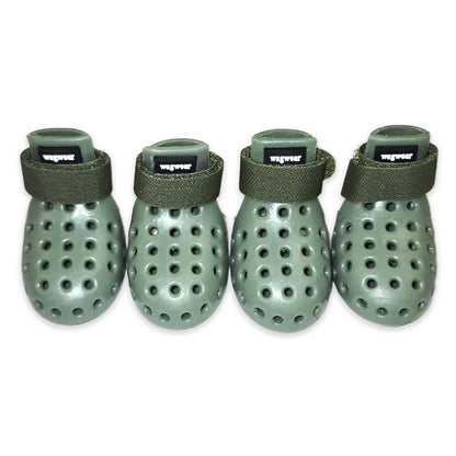 Four green dog booties with ventilation holes on a white background
